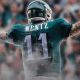 Back shot of Carson Wentz in an Eagles uniform with his arms stretched out, celebrating a touchdown.