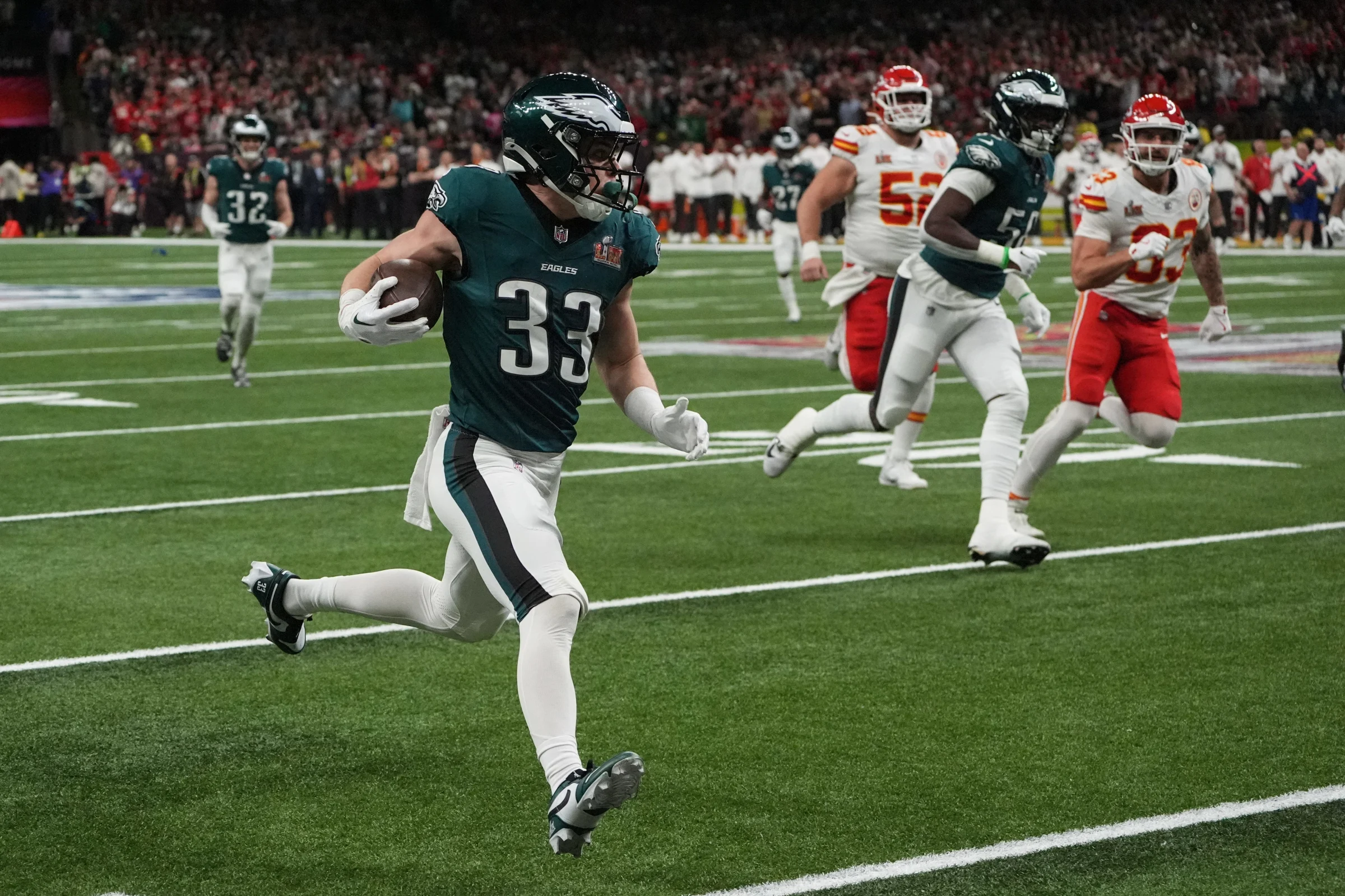 Cooper DeJean returns an interception for a touchdown down the sidelines before reaching the end zone.